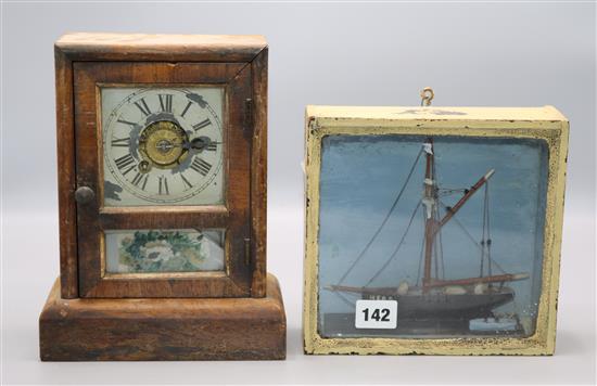 Model boat in case and a mantel clock